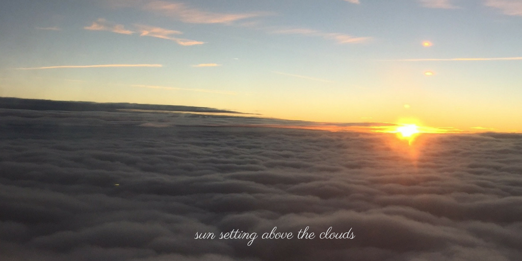 sun setting above the clouds