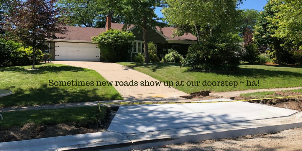 A new road being constructed in front of an older home