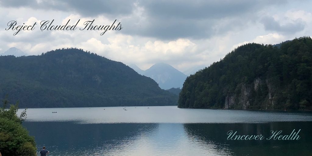 Cloudy sky with mountains over a calm lake
