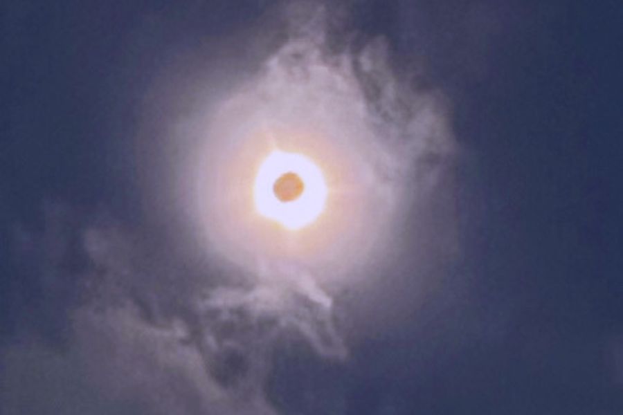 Total Solar Eclipse with image of a mermaid on top and dragon on the bottom.
